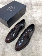 Prada lace-up dress shoes in dark brown glossy leather, angled front pair
