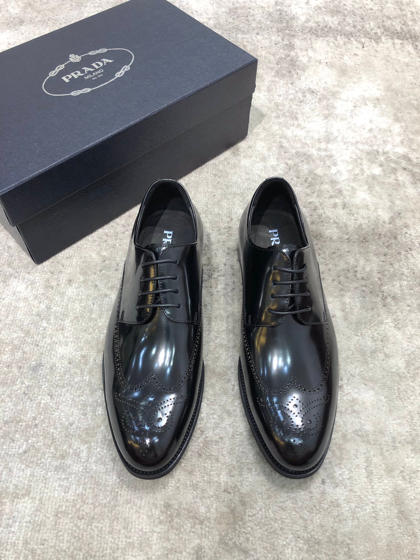 Prada unisex lace-up dress shoes in dark leather, glossy finish, with box