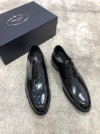 Prada lace-up dress shoes, black leather with wingtip-like perforations, with box