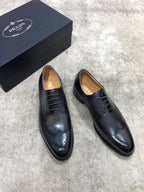 Prada black leather lace-up oxford shoes with brogue detailing, side angle view.