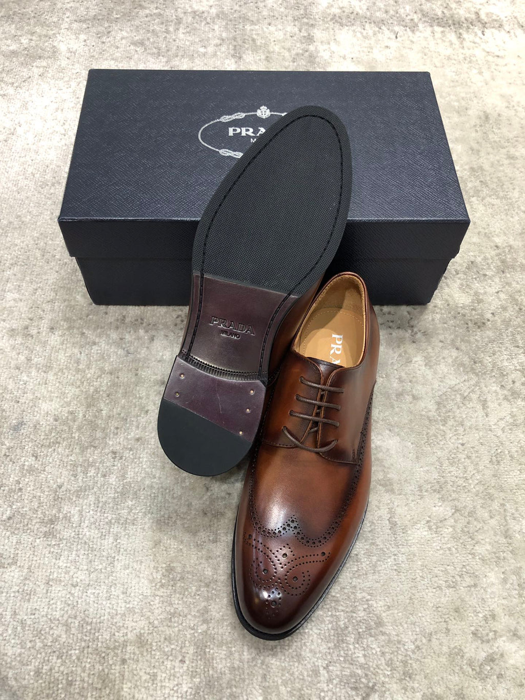 Prada brown leather lace-up brogue shoes with dark outsole and branded insole