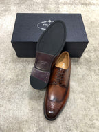 Prada brown leather lace-up brogue shoes with dark outsole and branded insole