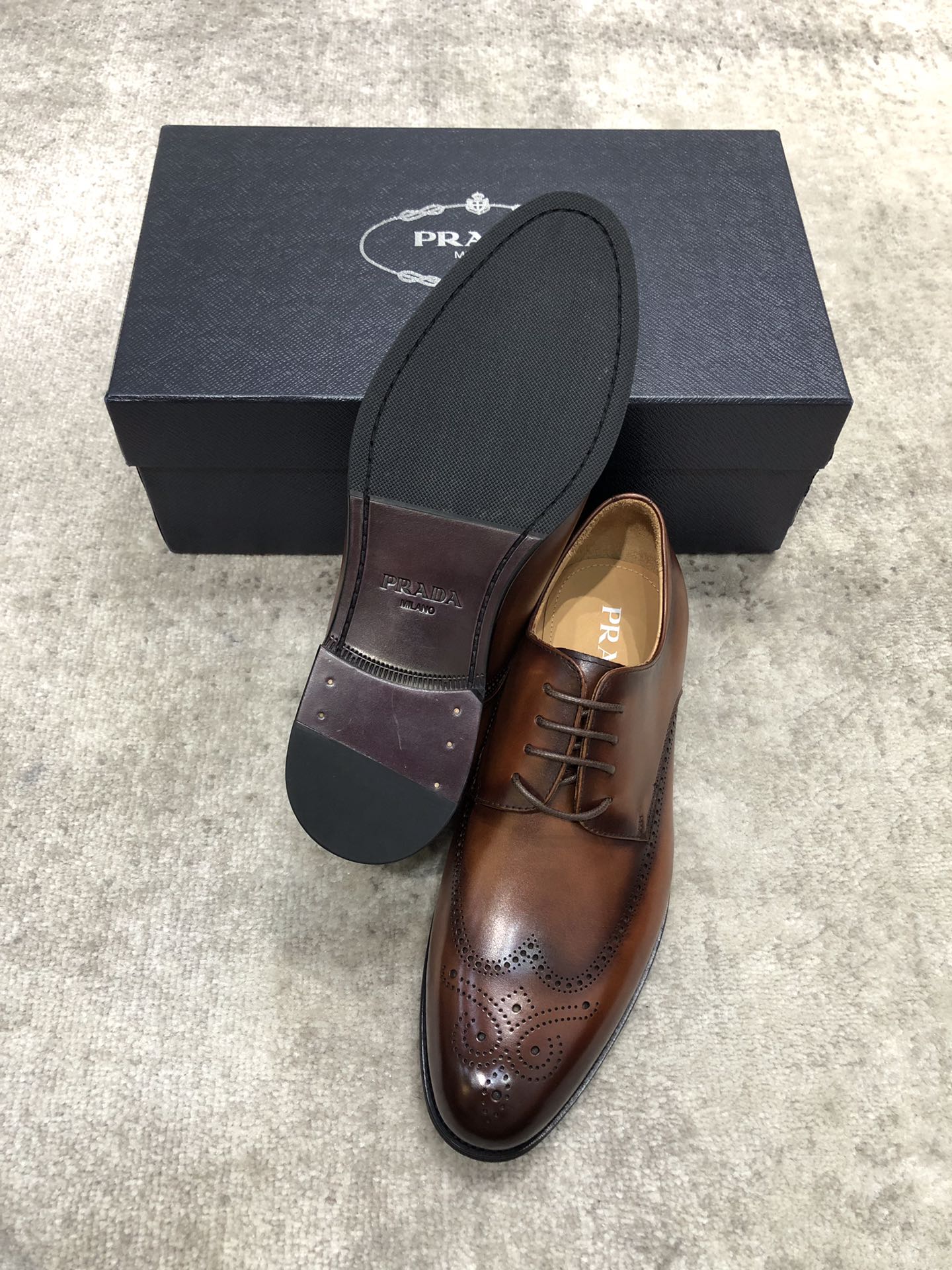 Prada brown leather lace-up brogue shoes with dark outsole and branded insole