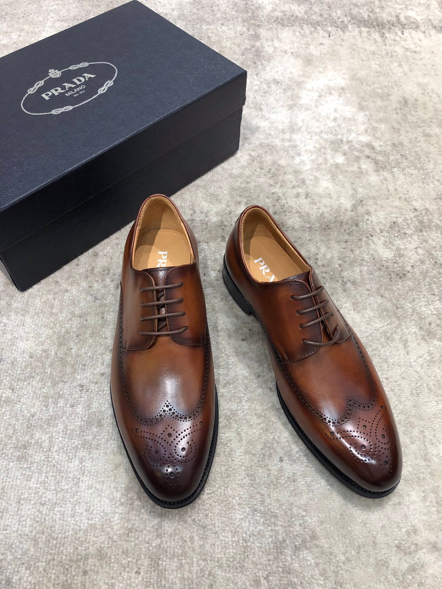 Prada brown leather lace-up brogue shoes, front view with lace eyelets