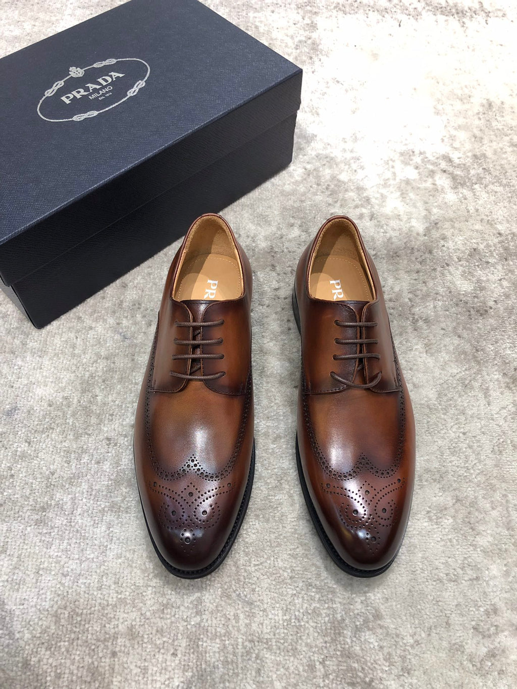 Prada unisex brown leather lace-up brogue shoes with perforated toe and black sole