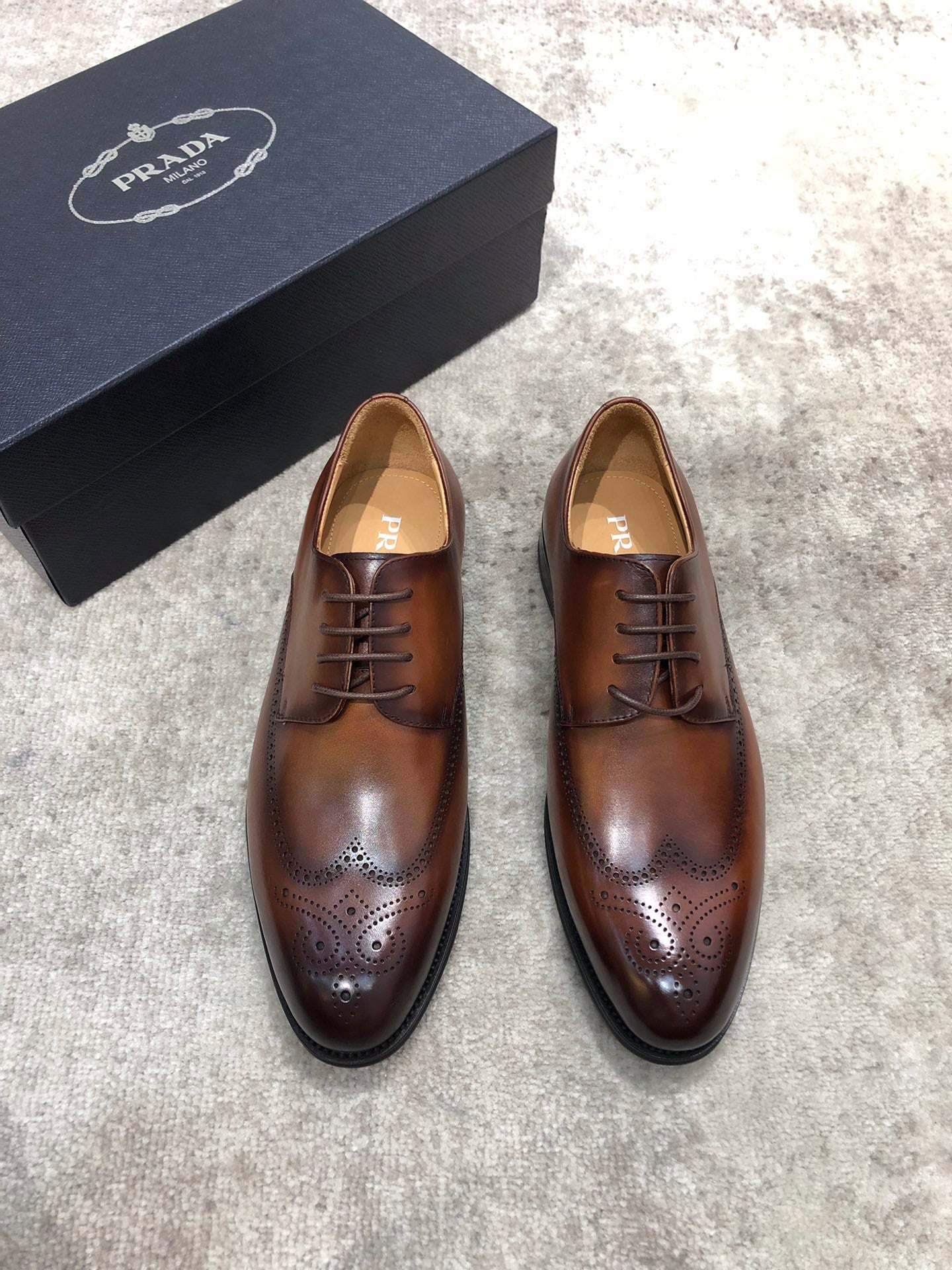 Prada unisex brown leather lace-up brogue shoes with perforated toe and black sole
