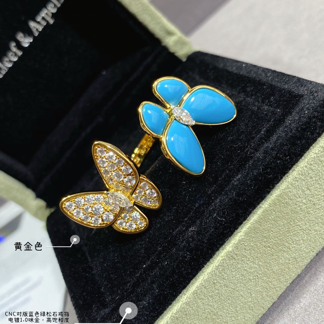 Butterfly earrings in black display box with blue enamel petals and gold-tone crystals