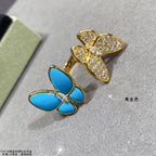 Butterfly earrings with blue enamel petals and clear stone pavé in gold-tone settings