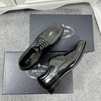 Prada unisex lace-up dress shoes, black leather with glossy finish and lace-up vamp.