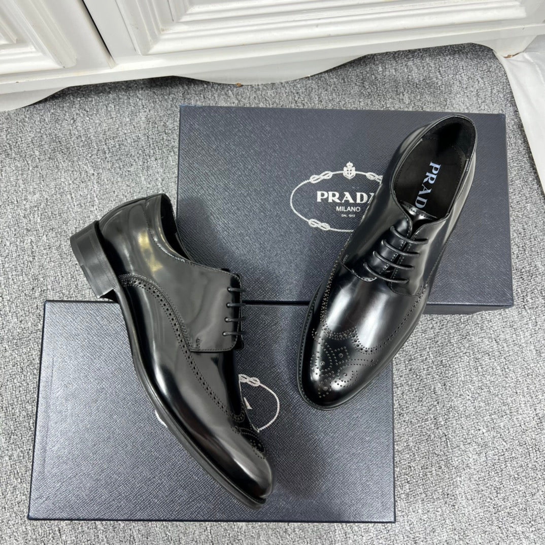 Prada unisex lace-up dress shoes, black leather with brogue perforations and laces.