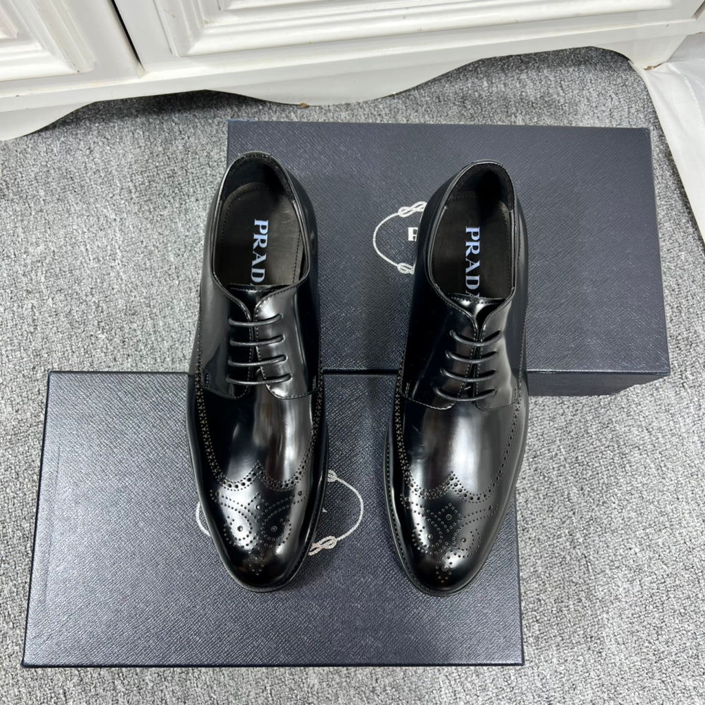 Prada unisex lace-up dress shoes, black leather with brogue details and glossy finish.