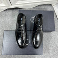 Prada unisex lace-up dress shoes, black leather with brogue details and glossy finish.