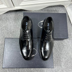 Prada unisex lace-up dress shoes, black leather with brogue details and glossy finish.