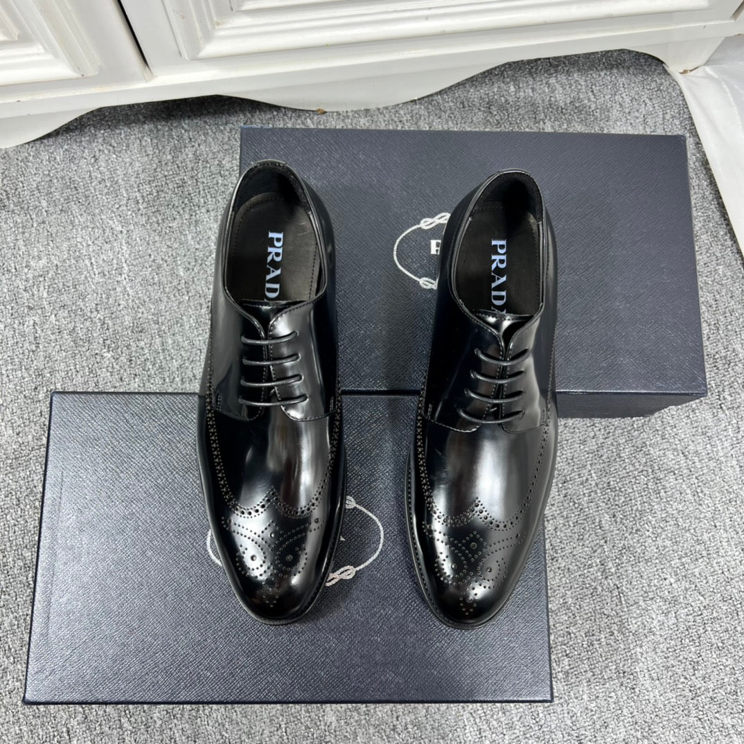 Prada unisex lace-up dress shoes, black leather with brogue details and glossy finish.
