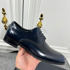 Prada unisex lace-up derby shoe in dark navy leather with brogue stitching and cap toe