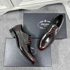 Prada unisex leather lace-up dress shoes, burgundy-toned brogue detailing