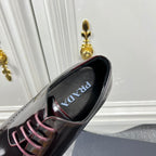 Prada unisex leather lace-up dress shoe, close-up of lace and logo tongue