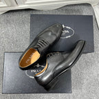 Prada unisex lace-up dress shoes, dark leather with perforated upper