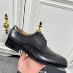 Prada unisex oxford shoes in black leather, lace-up with wingtip brogue pattern.
