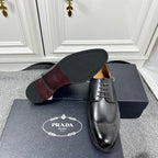 Prada unisex oxford shoes in black leather, sole and side view with lace-up.