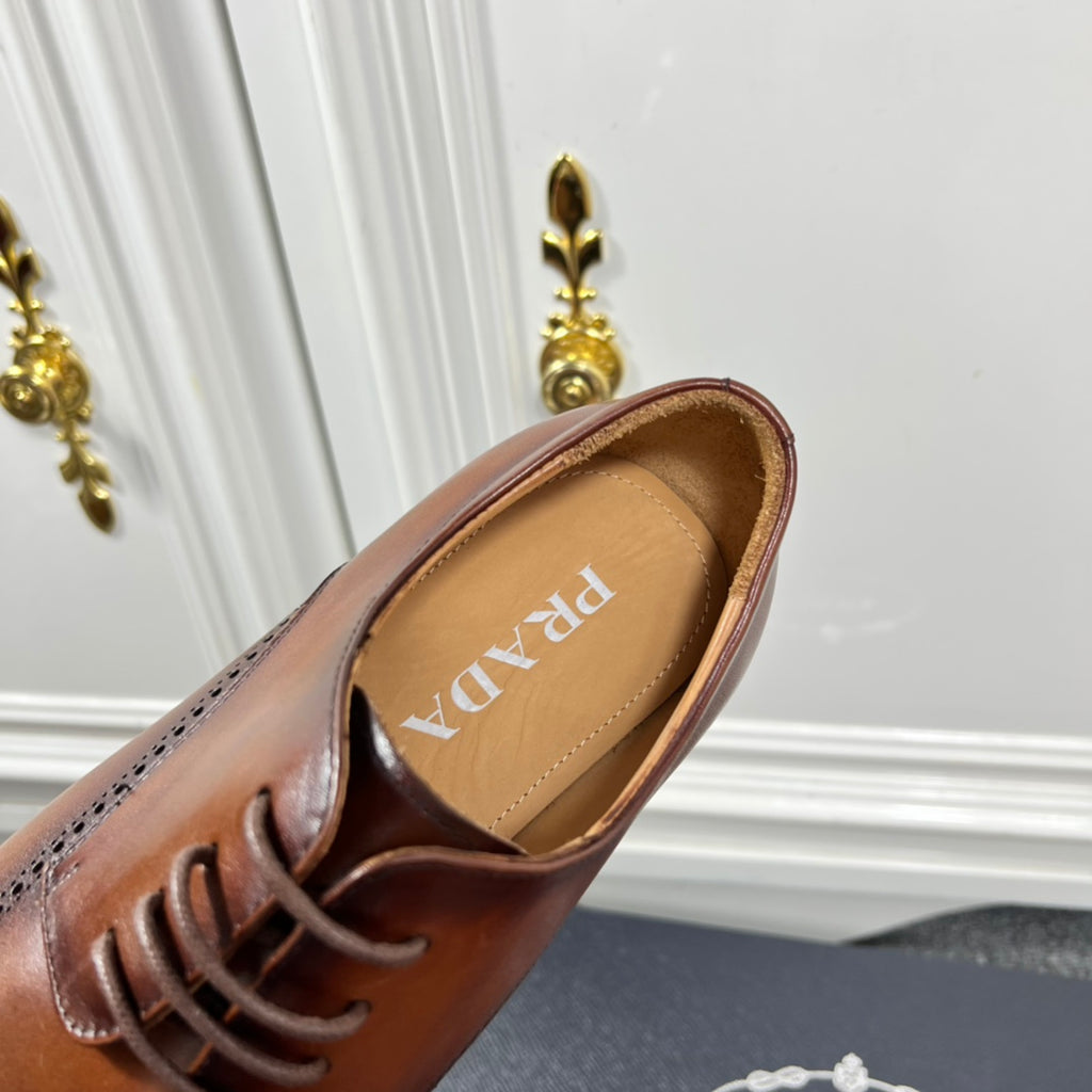 Prada unisex lace-up oxford shoe close-up, dark brown leather and tan interior with Prada text