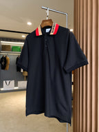 Black Burberry polo shirt on hanger, red-and-beige striped collar