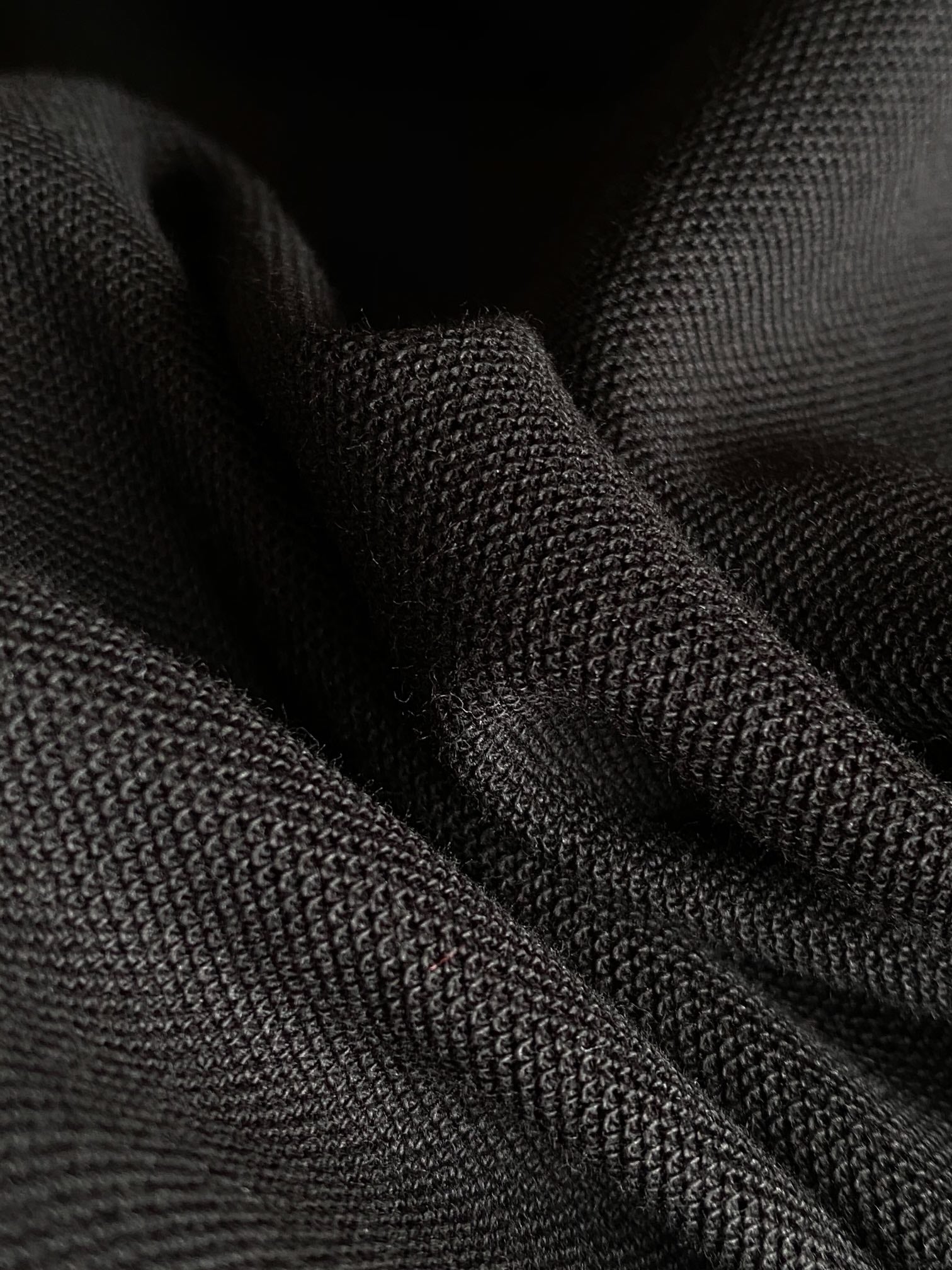 Black polo fabric texture close-up
