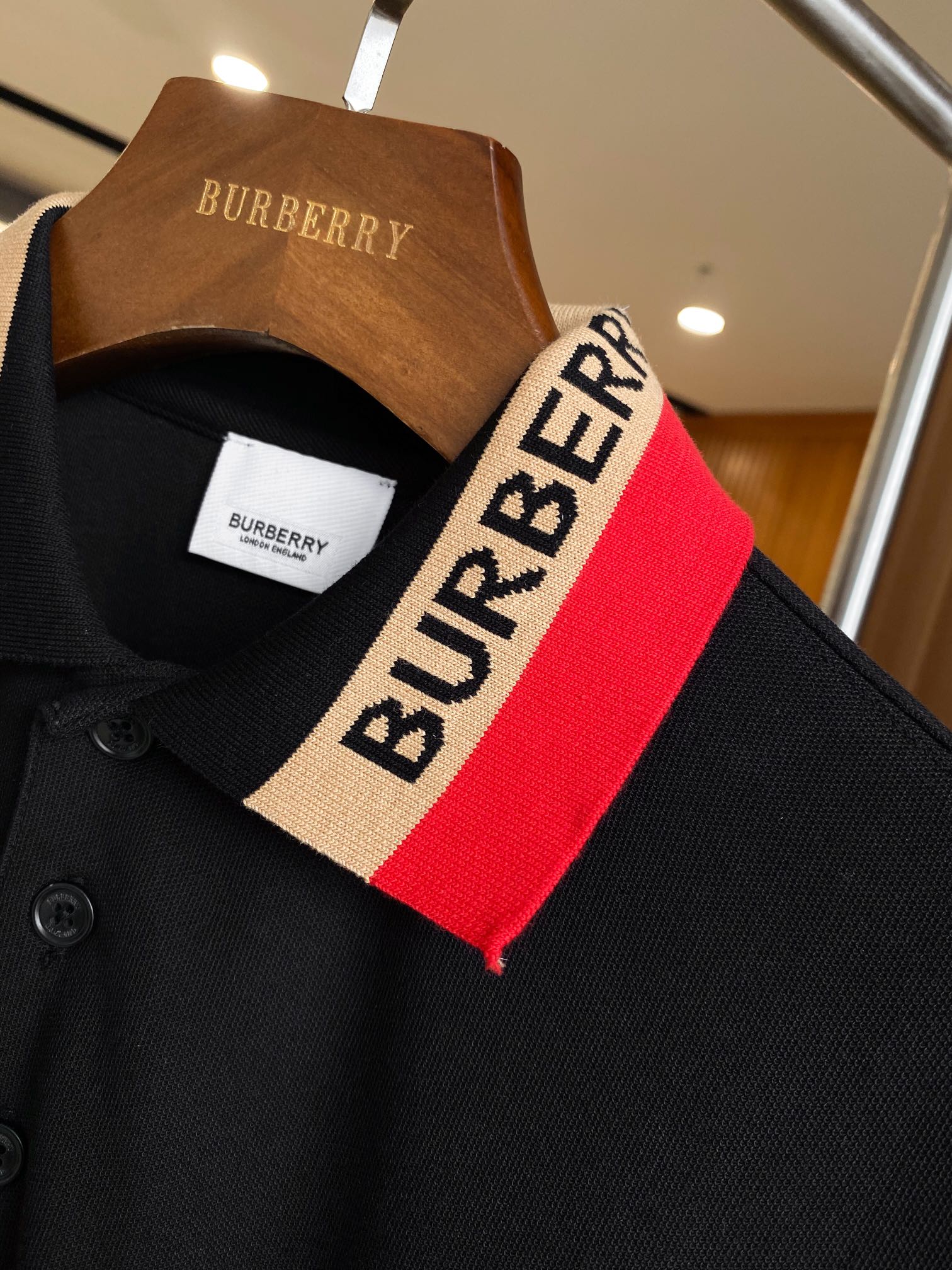 Black Burberry polo collar with red and beige striped trim