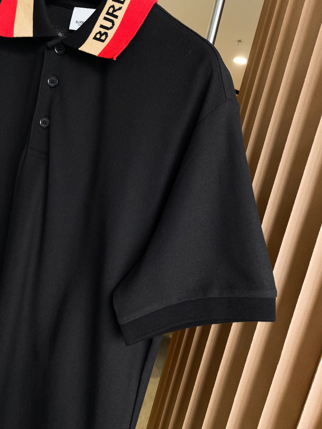 Black Burberry polo shirt shoulder and short sleeve cuff