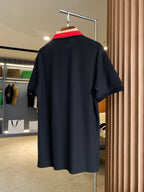 Back view of black Burberry polo shirt on hanger