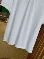 Burberry white polo shirt hem and short sleeves, side view