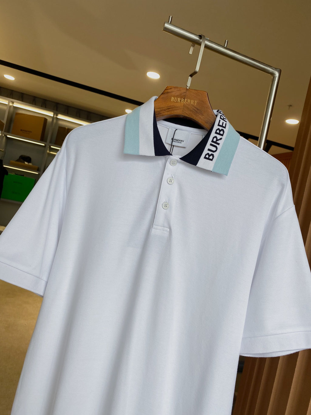 Burberry white polo shirt on hanger, tipped collar with light blue logo stripe