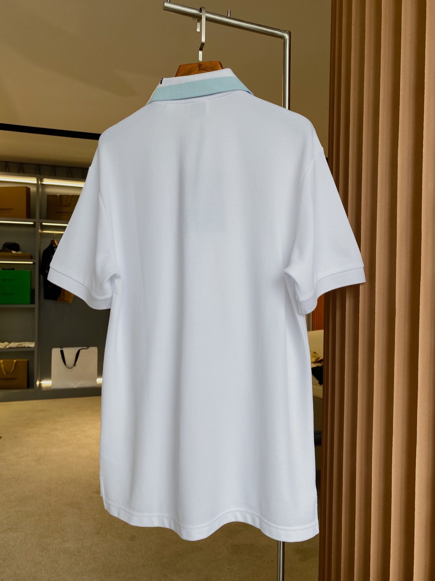 Burberry white polo shirt back view on hanger
