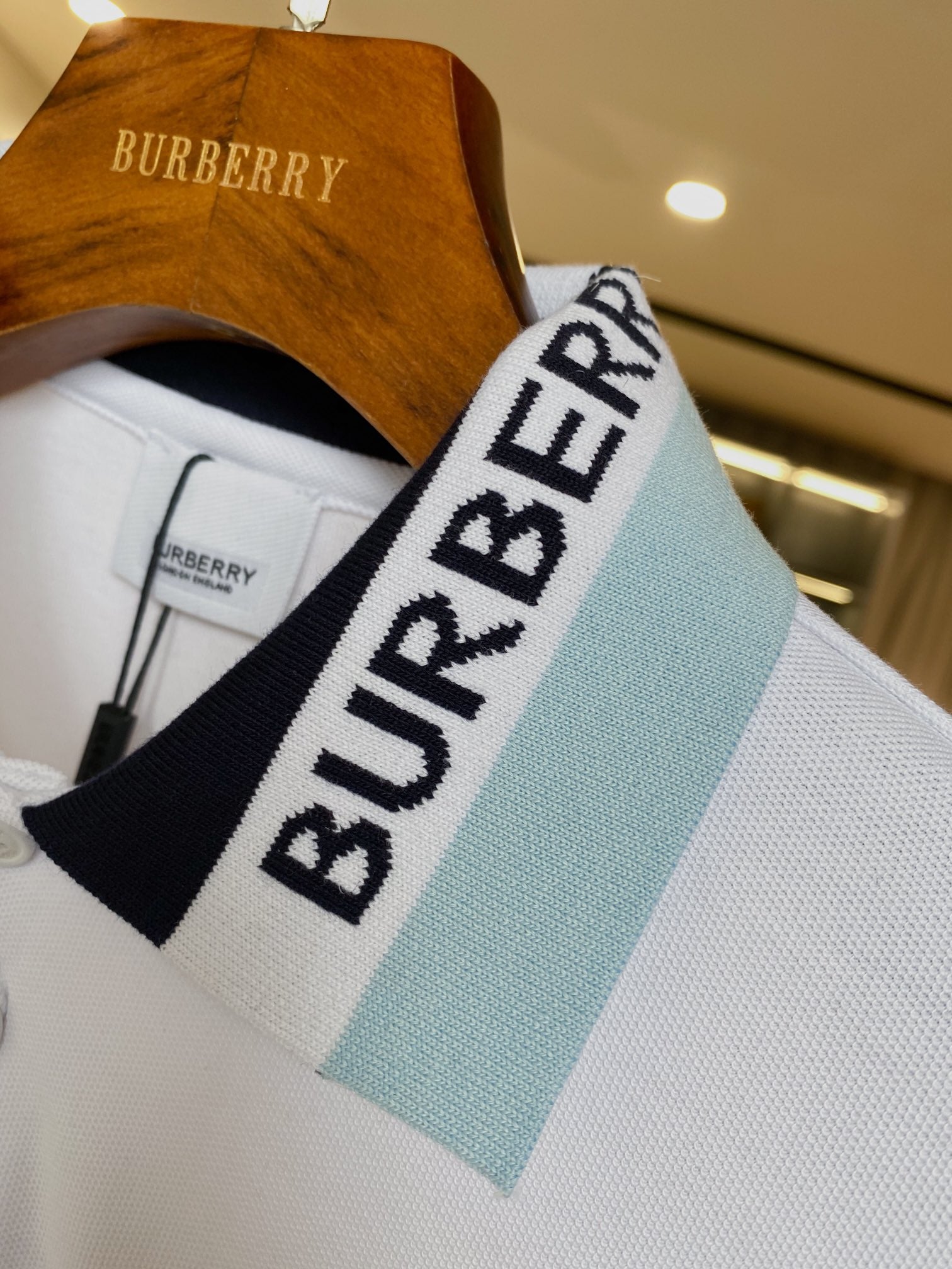 Burberry polo shirt neckline with light blue and black logo band collar