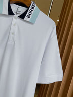 Burberry white polo shirt with open collar and light blue logo tape