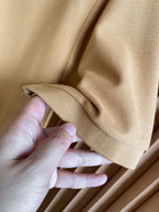 Beige Burberry polo sleeve cuff close-up held by hand