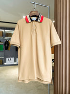 Beige Burberry polo shirt with button placket and navy collar stripe detail