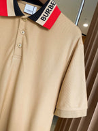 Beige Burberry polo close-up of navy collar stripe and buttoned front