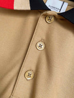Beige Burberry polo fabric close-up with round logo buttons on placket