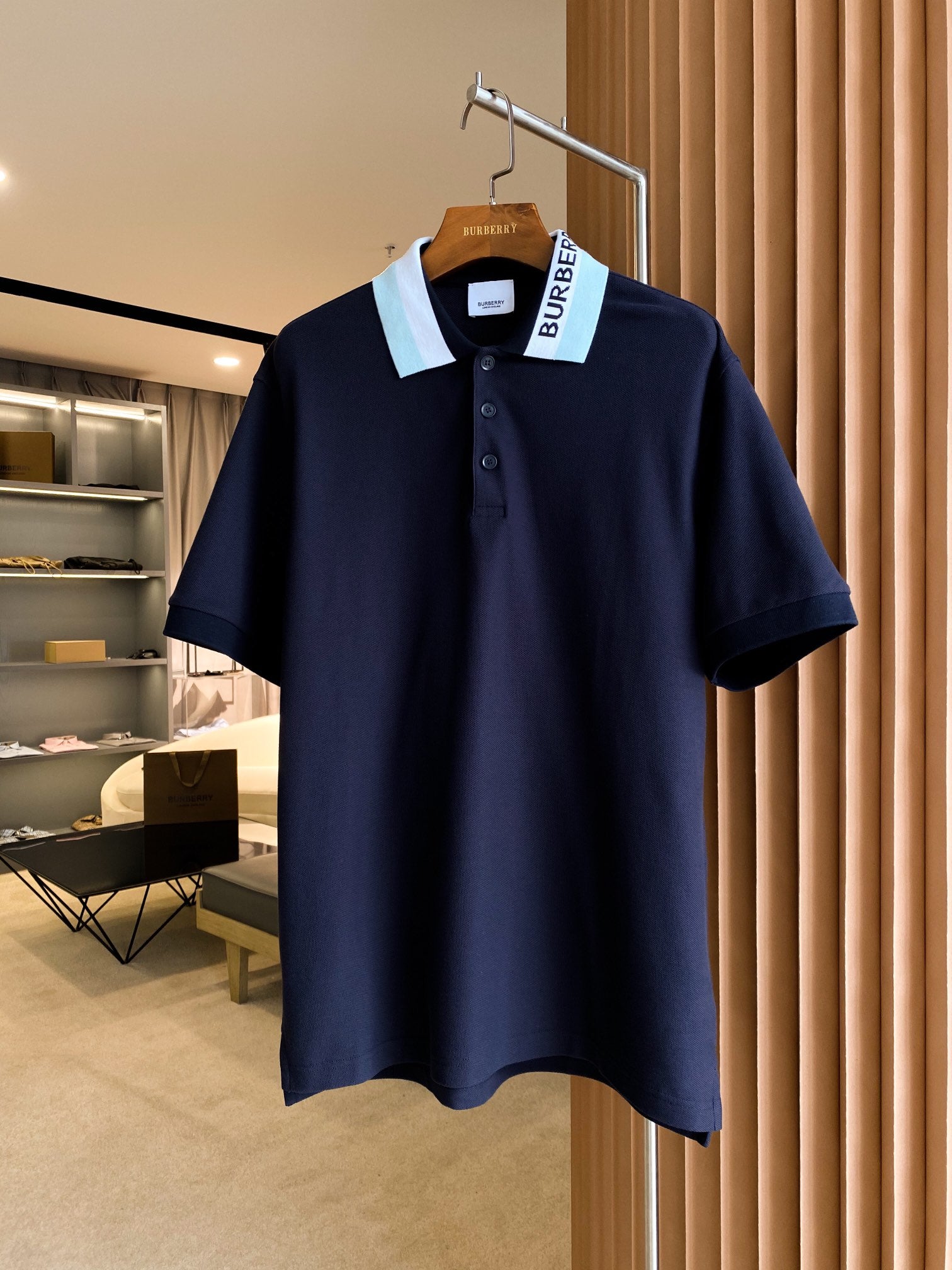 Navy Burberry polo shirt with short sleeves and button placket