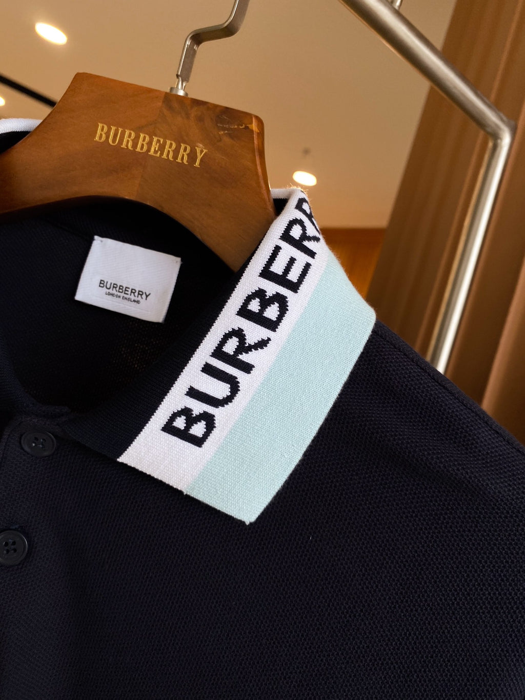 Navy polo shirt with white and light-blue striped collar and Burberry label