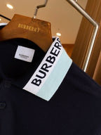 Navy polo shirt with white and light-blue striped collar and Burberry label
