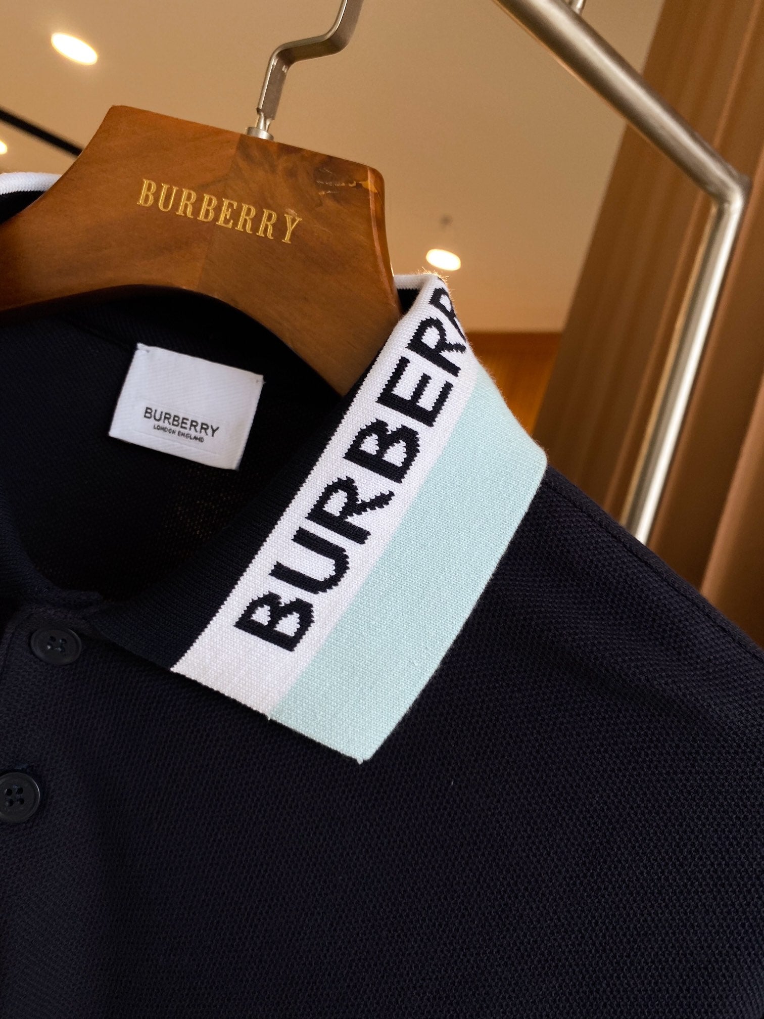 Navy polo shirt with white and light-blue striped collar and Burberry label