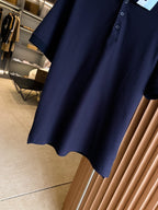 Navy polo shirt hem with short sleeves and buttoned front placket