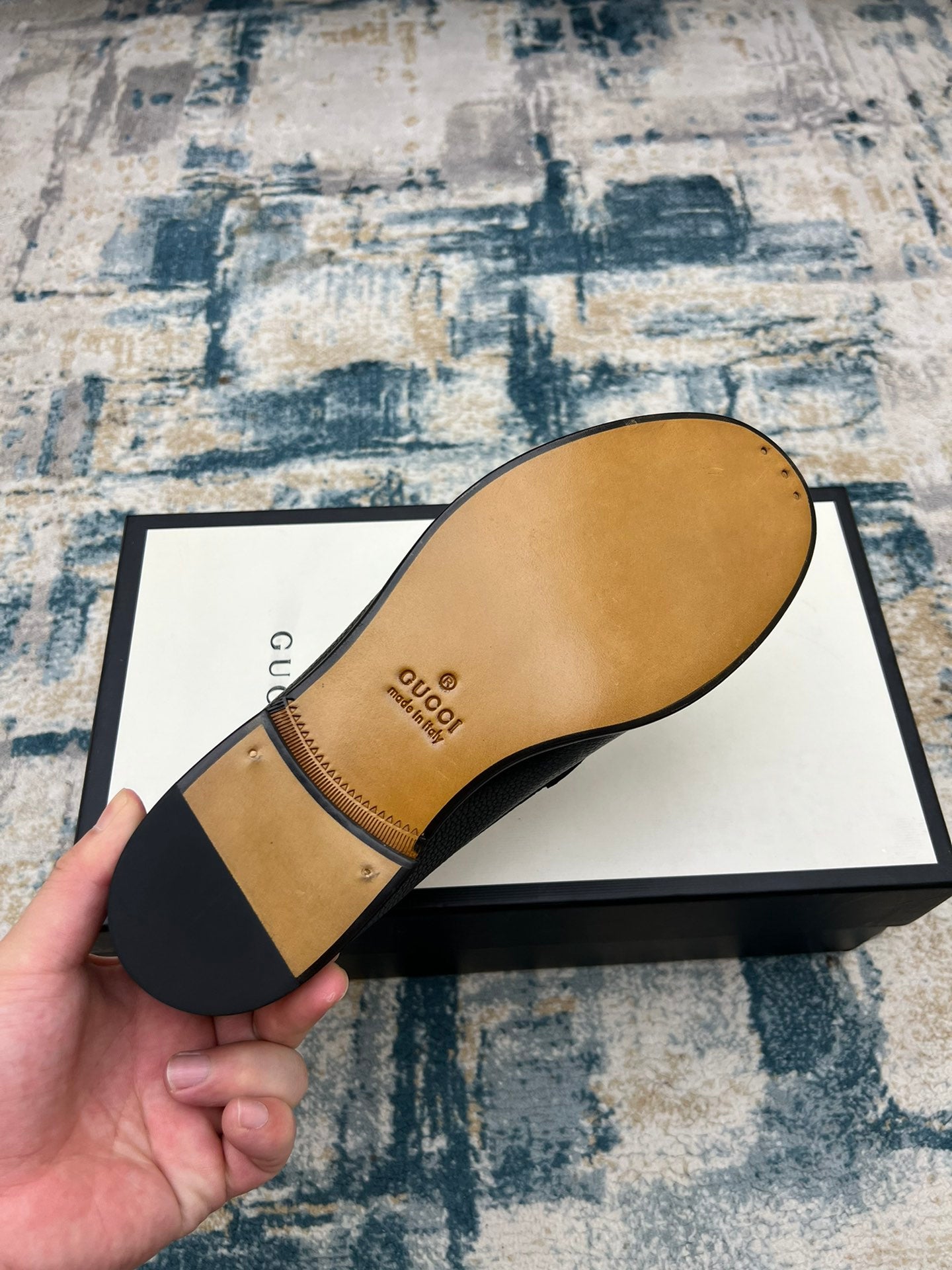 Black Gucci unisex loafer sole and heel view, with tan interior lining visible
