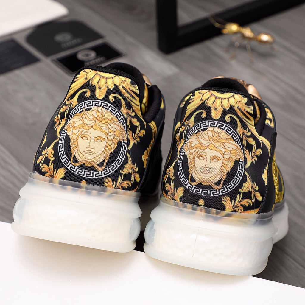 Men's Versace sneakers, gold Medusa-style back print on black and white rubber sole.