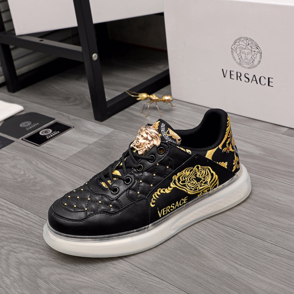 Men's Versace sneakers, black leather with gold baroque paneling and white rubber sole.