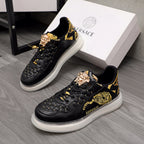 Men's Versace sneakers, black leather with gold baroque print and white rubber sole.
