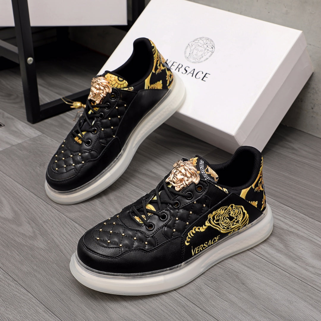 Men's Versace sneakers, black leather with gold baroque print and white rubber sole.