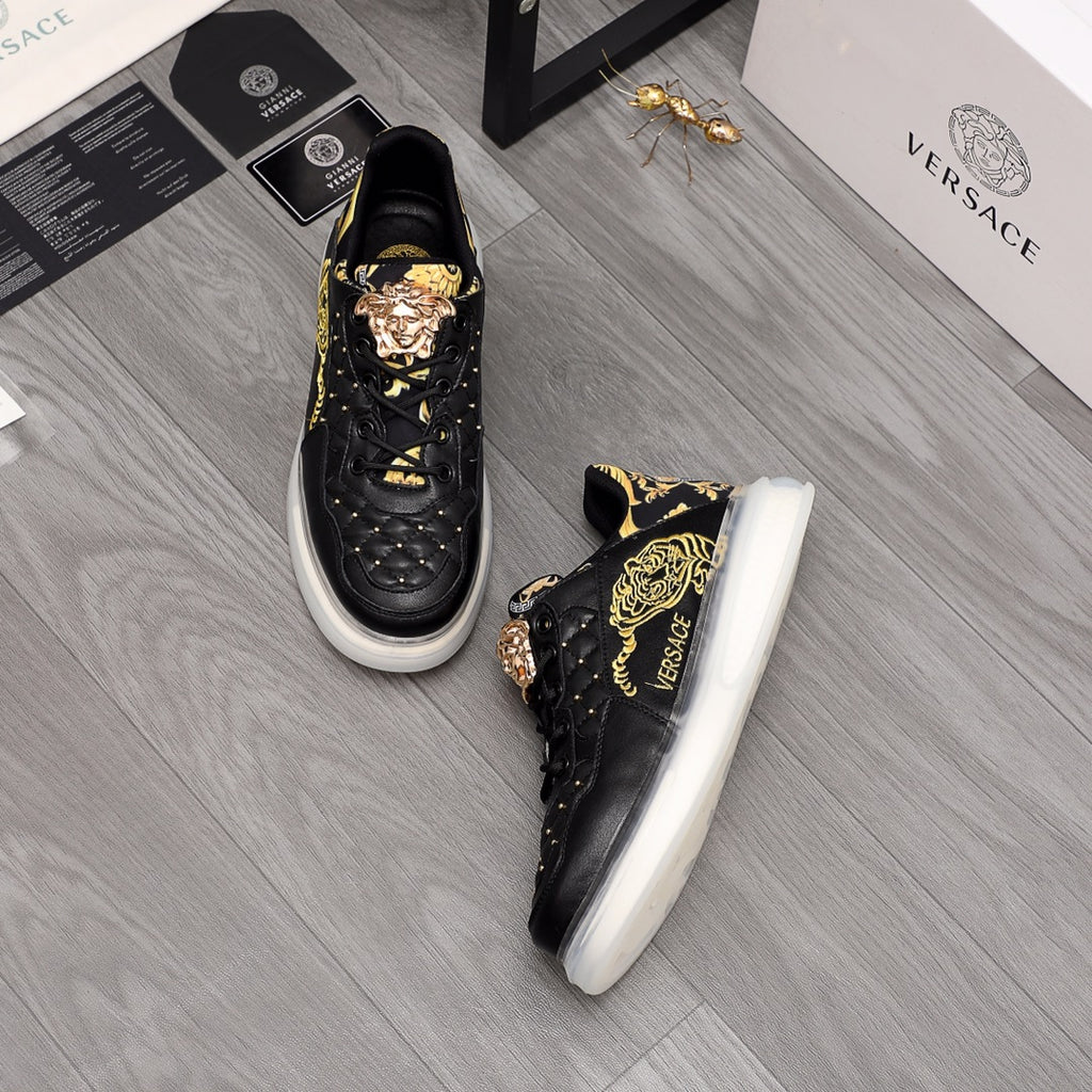 Men's Versace sneakers, black with gold ornament graphics, white sole, lace-up.